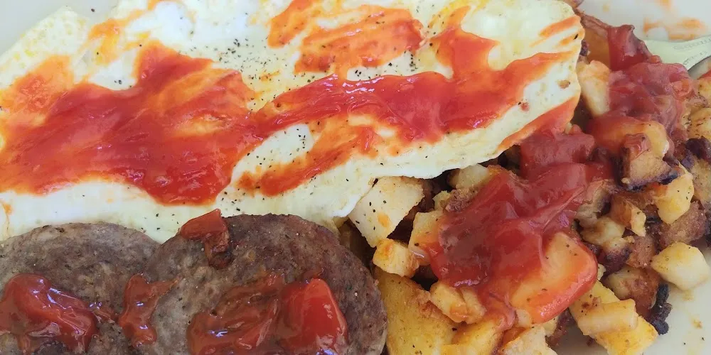 Two Eggs over Medium Sausage Patties and Home Fries